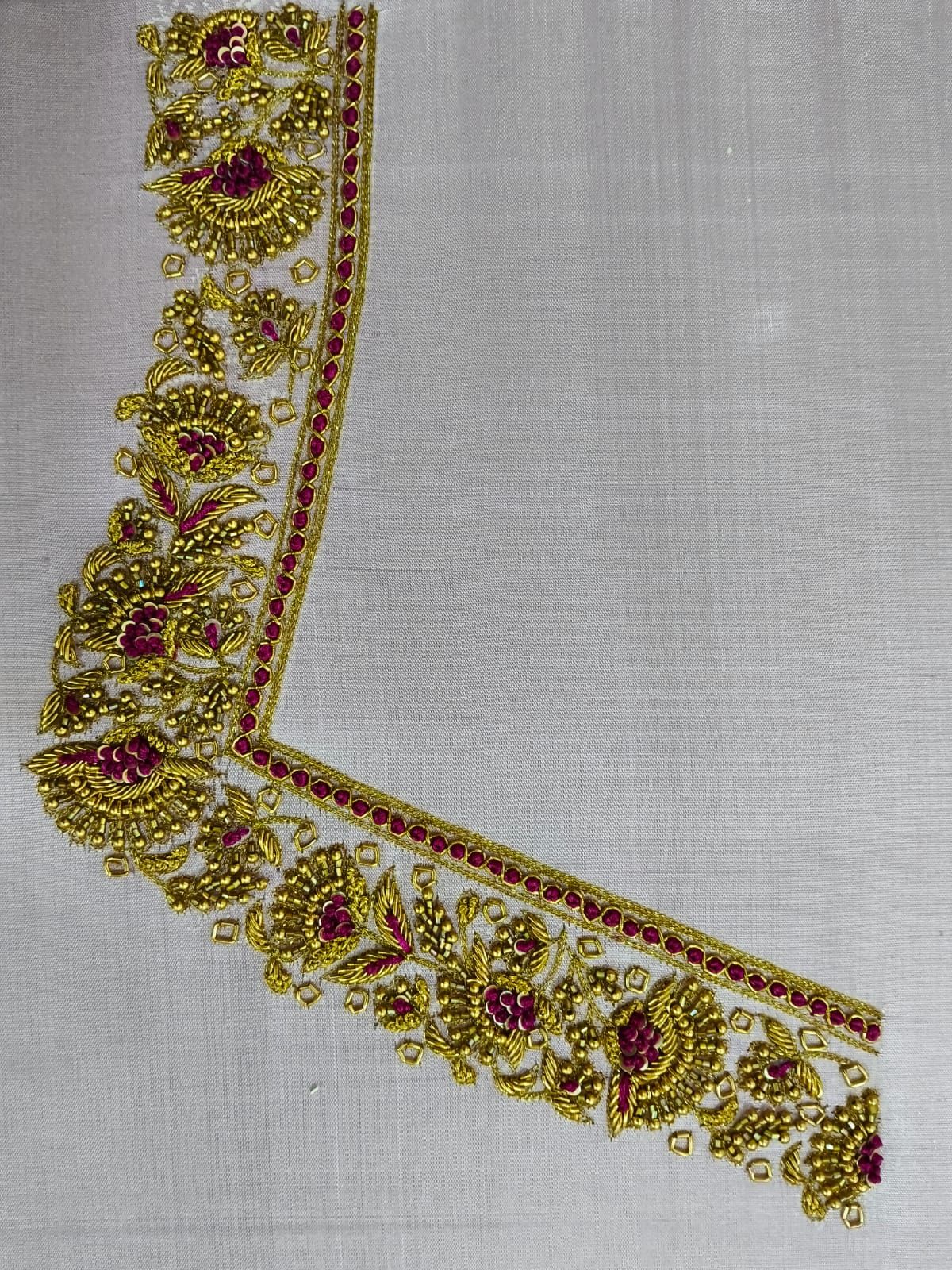 Gold zardosi neckline border with maroon stones worked by hand on ivory silk