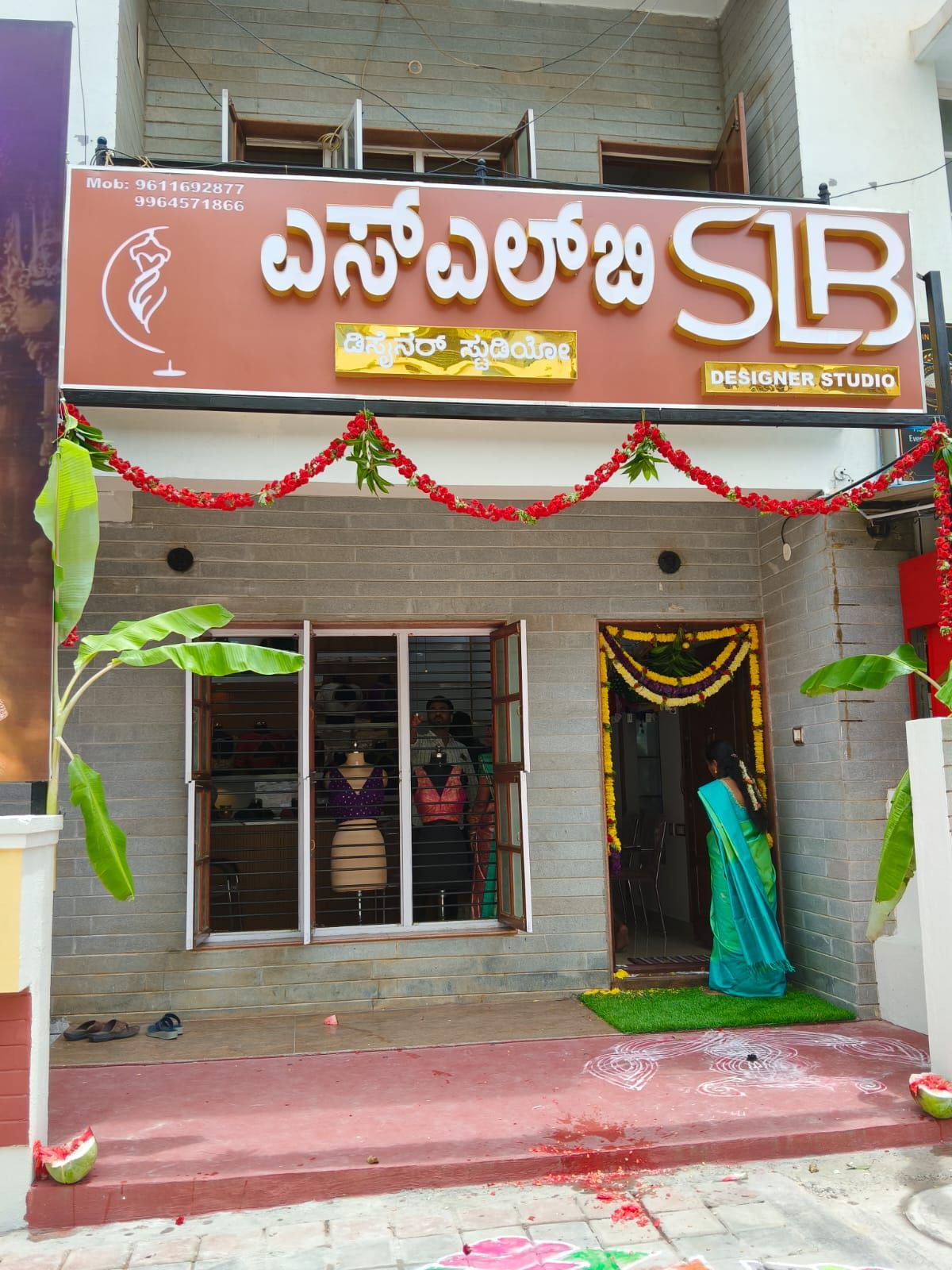 SLB Designer Studio entrance decorated with marigold garlands, with garments displayed in the window